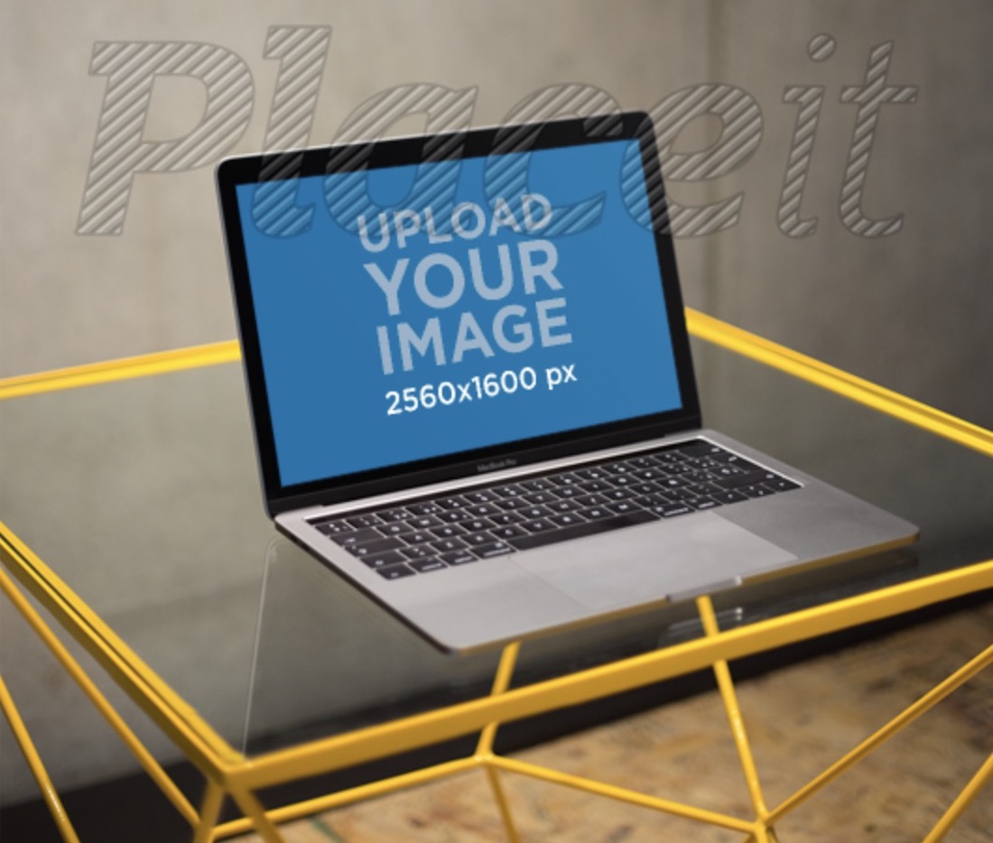 Macbook maquete em uma mesa de vidro